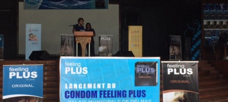 Banners for Feeling Plus condoms and SHOPS Plus decorate a stage